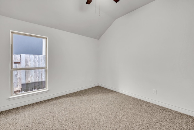 carpeted empty room featuring lofted ceiling and ceiling fan