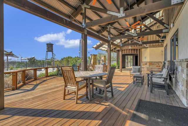 wooden terrace featuring a gazebo and ceiling fan