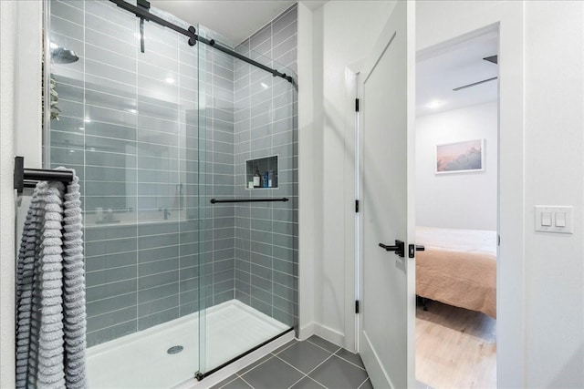 bathroom with an enclosed shower and tile patterned floors