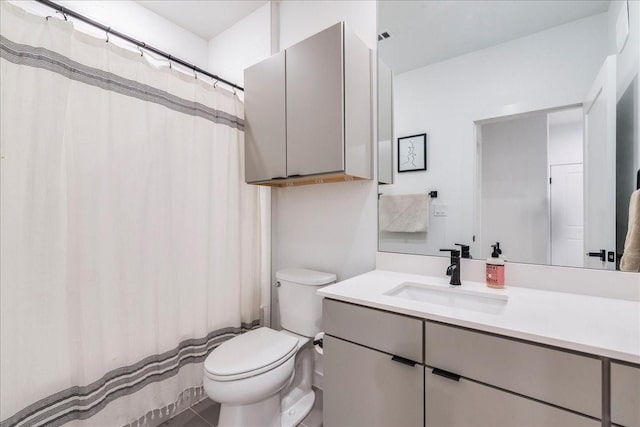 bathroom featuring toilet, tile patterned flooring, and vanity