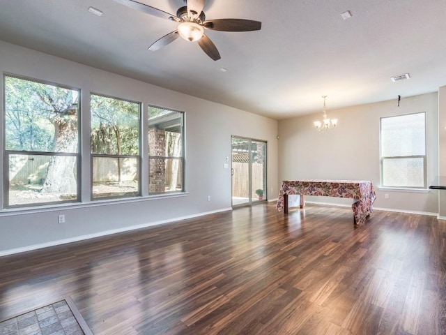 737 Foxtail Run, San Marcos, TX 78666 - unfurnished living room featuring dark wood finished floors, a ceiling fan, and a chandelier