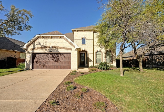 view of front facade with a garage and a front lawn