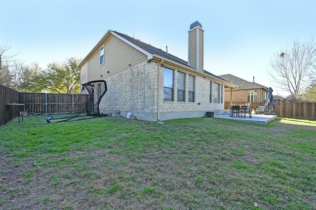 rear view of property featuring a patio area and a yard