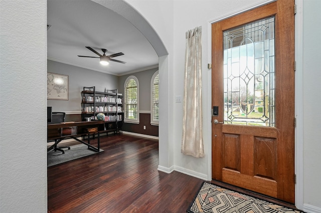 entryway featuring ornamental molding, dark wood-type flooring, and ceiling fan