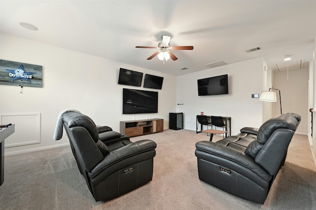 carpeted living room featuring ceiling fan