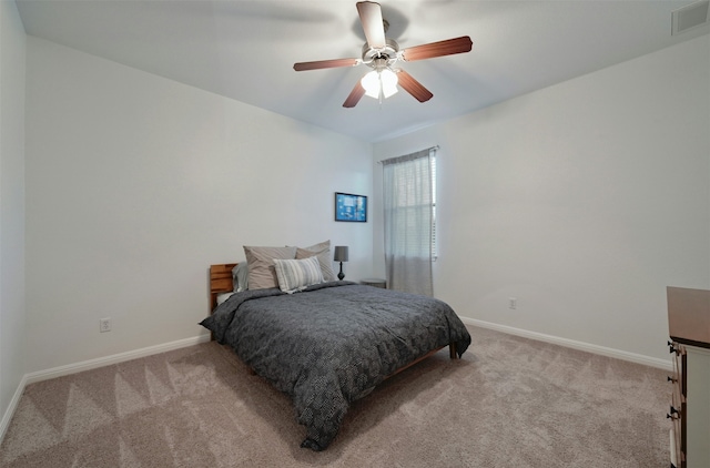 bedroom featuring ceiling fan and light carpet