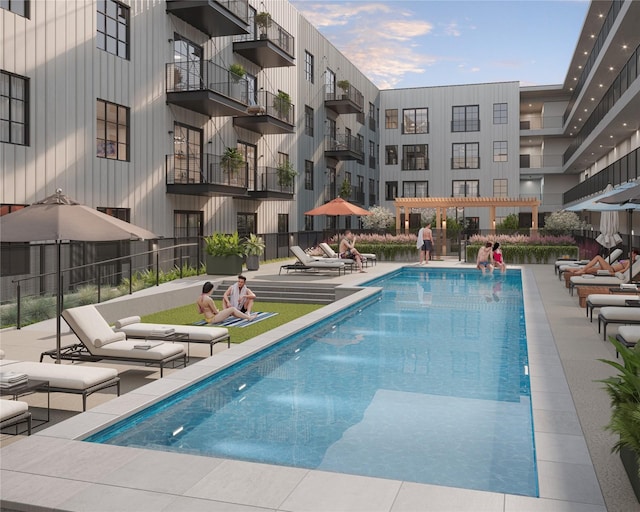 view of swimming pool featuring a patio, pool water feature, and a pergola