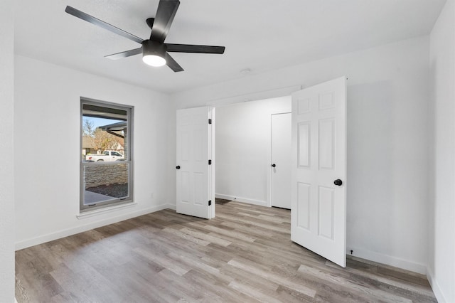 unfurnished bedroom featuring ceiling fan and light hardwood / wood-style floors