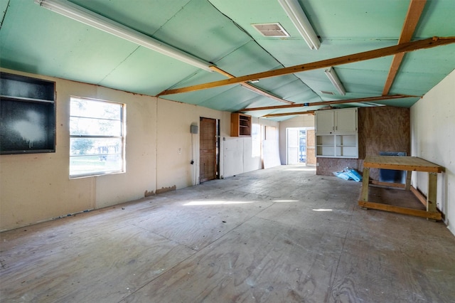 interior space featuring lofted ceiling and plenty of natural light