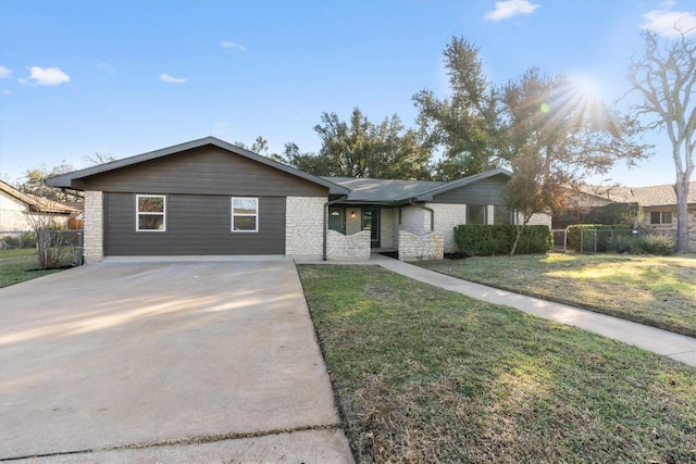 ranch-style house with stone siding, driveway, a front lawn, and fence