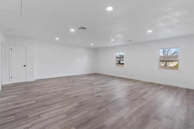 spare room featuring light wood-type flooring