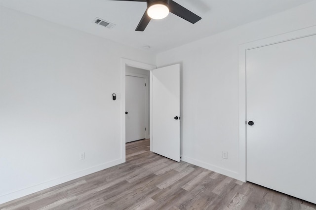 unfurnished bedroom featuring ceiling fan and light wood-type flooring