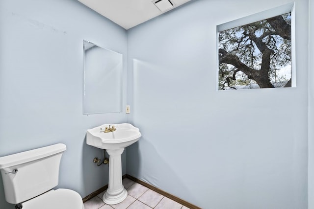 bathroom with toilet and tile patterned floors