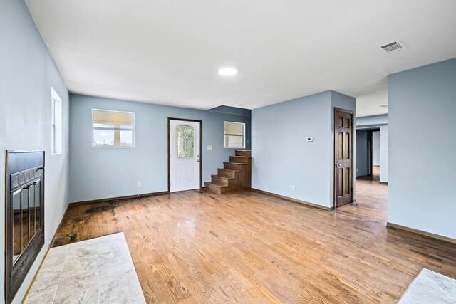 unfurnished living room with light wood-type flooring