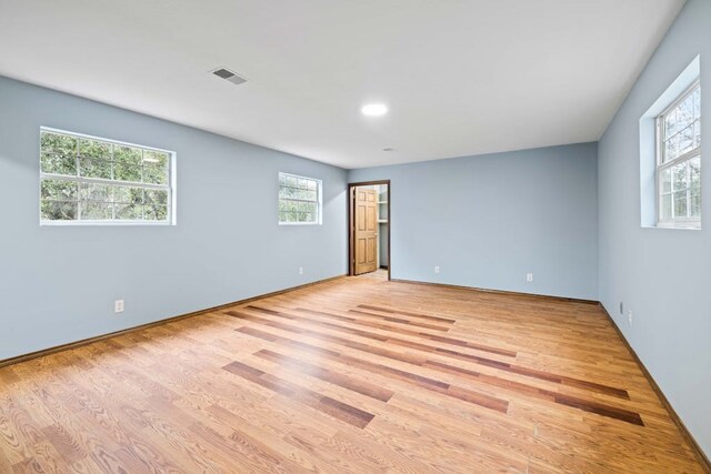 spare room with light hardwood / wood-style flooring