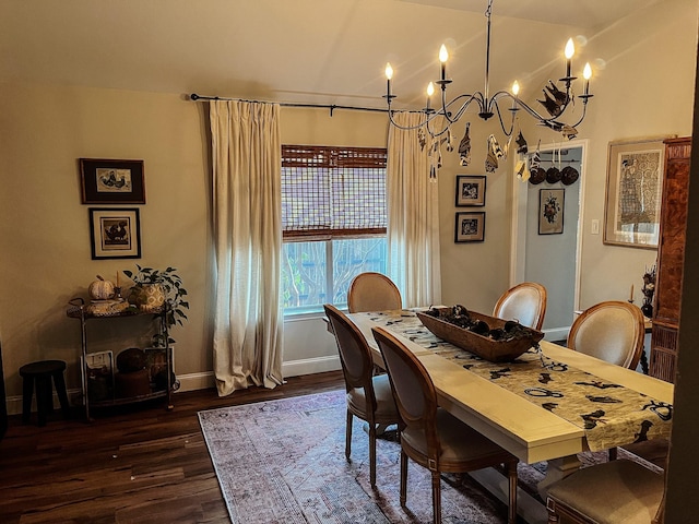 dining space with dark hardwood / wood-style flooring and a notable chandelier