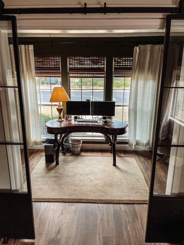 home office with wood-type flooring