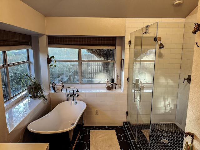 bathroom featuring tile patterned flooring, tile walls, and plus walk in shower