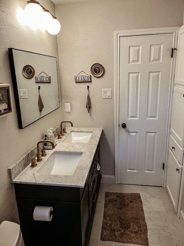 bathroom with toilet and vanity