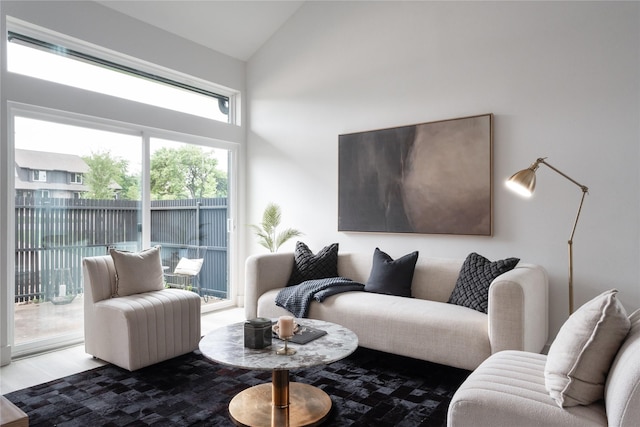 living room featuring hardwood / wood-style floors and vaulted ceiling