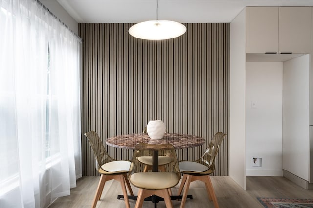 dining space with light hardwood / wood-style flooring