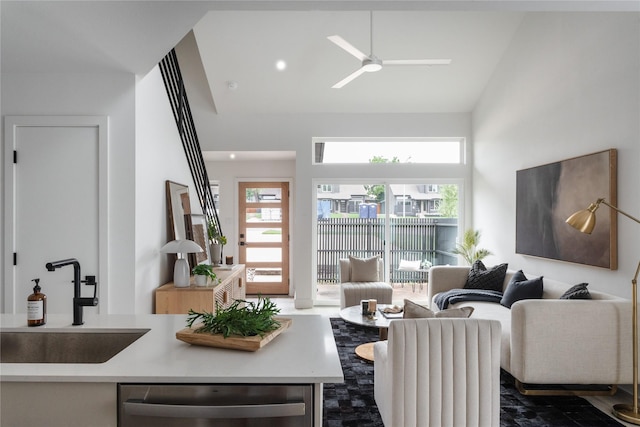 living room with sink, ceiling fan, and lofted ceiling