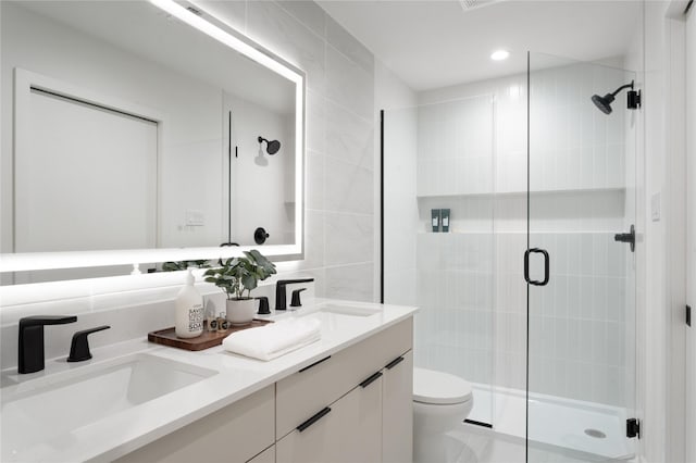 bathroom featuring tile walls, toilet, walk in shower, and vanity