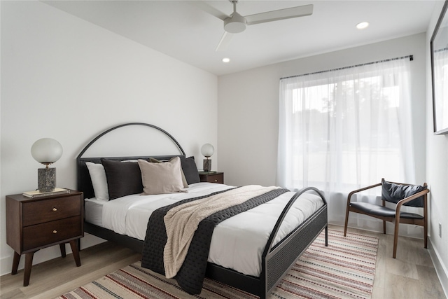 bedroom with ceiling fan and light hardwood / wood-style flooring