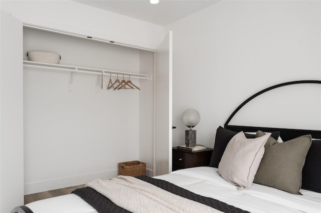 bedroom with hardwood / wood-style flooring and a closet