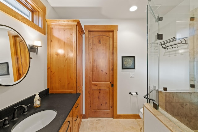 bathroom with toilet, a shower with door, vanity, and tile patterned floors