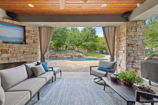 view of patio / terrace with area for grilling, ceiling fan, and outdoor lounge area