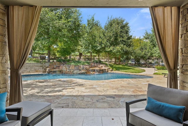 view of swimming pool featuring pool water feature and a patio area