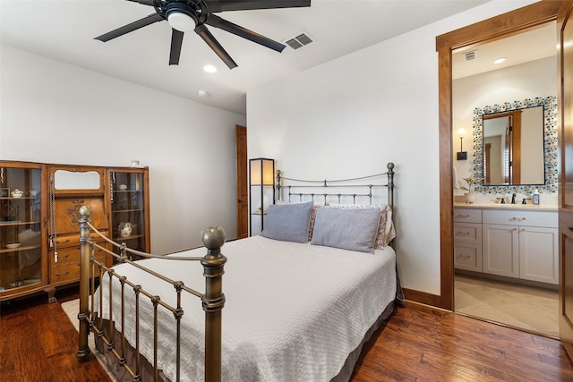 bedroom with sink, dark wood-type flooring, ceiling fan, and connected bathroom