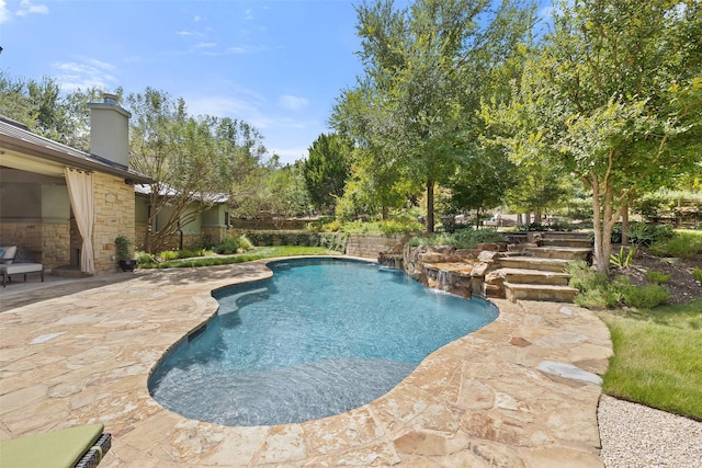 view of pool with a patio and pool water feature