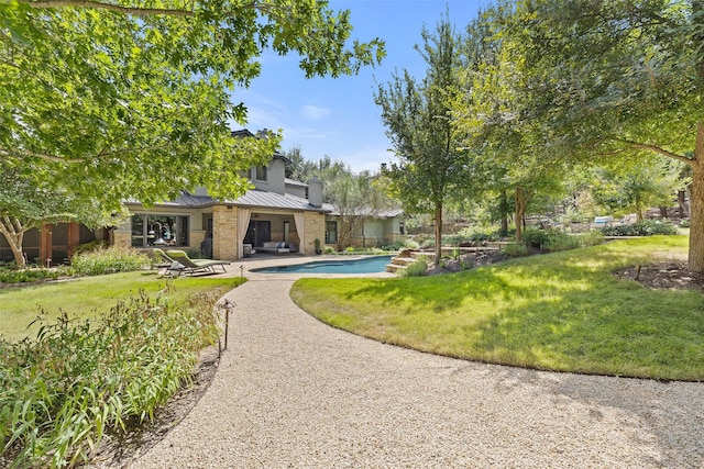 exterior space featuring a pool, a patio, and a yard