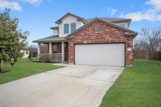 view of property featuring a garage, a front yard, and covered porch