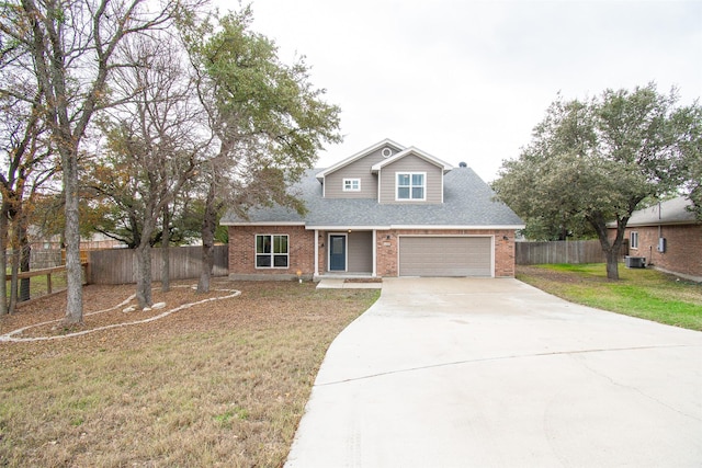 view of front of house with central AC, a front lawn, and a garage