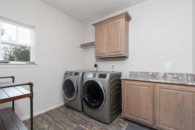 washroom with cabinets, washing machine and clothes dryer, and dark hardwood / wood-style floors