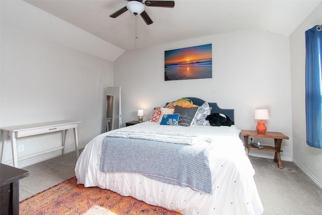 bedroom with ceiling fan, vaulted ceiling, and carpet floors