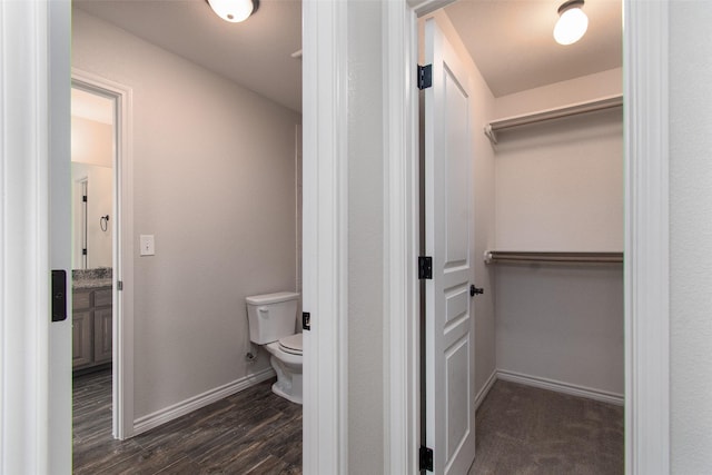 bathroom featuring hardwood / wood-style floors and toilet