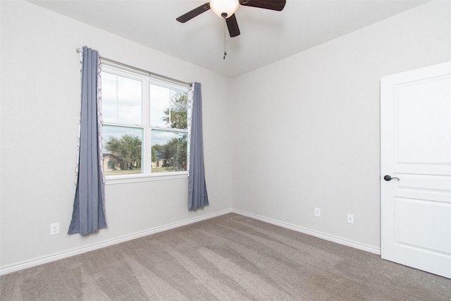 empty room featuring light carpet and ceiling fan