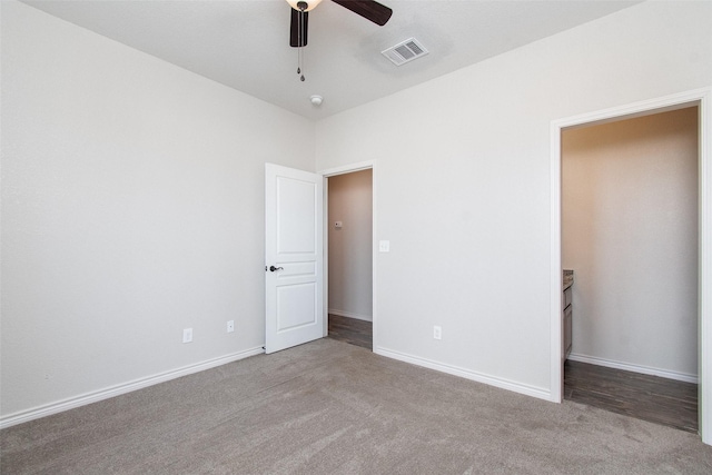 unfurnished bedroom with light colored carpet and ceiling fan