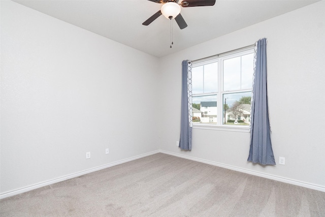 carpeted spare room with ceiling fan