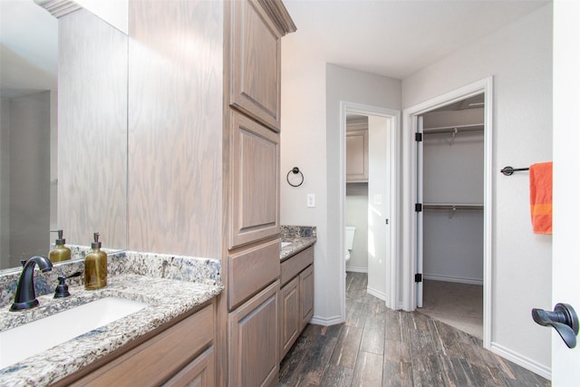 bathroom with vanity, hardwood / wood-style flooring, and toilet