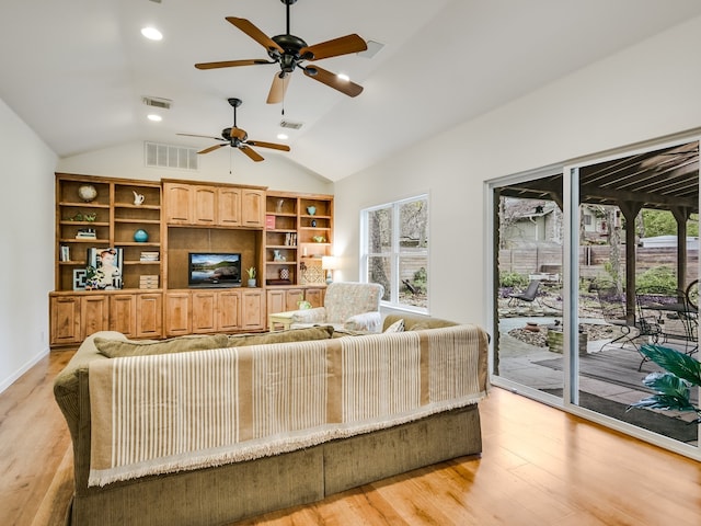 living room with ceiling fan, built in features, light hardwood / wood-style flooring, and lofted ceiling