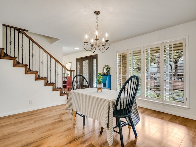 dining room featuring a chandelier and light hardwood / wood-style flooring