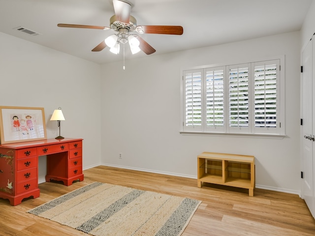 home office with ceiling fan and light wood-type flooring