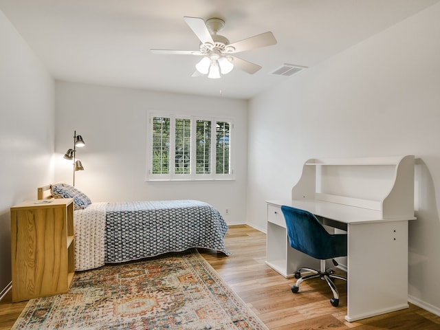 bedroom with ceiling fan and light hardwood / wood-style floors