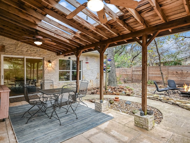 view of patio / terrace featuring ceiling fan and an outdoor fire pit