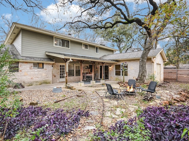 back of house with a patio and a fire pit